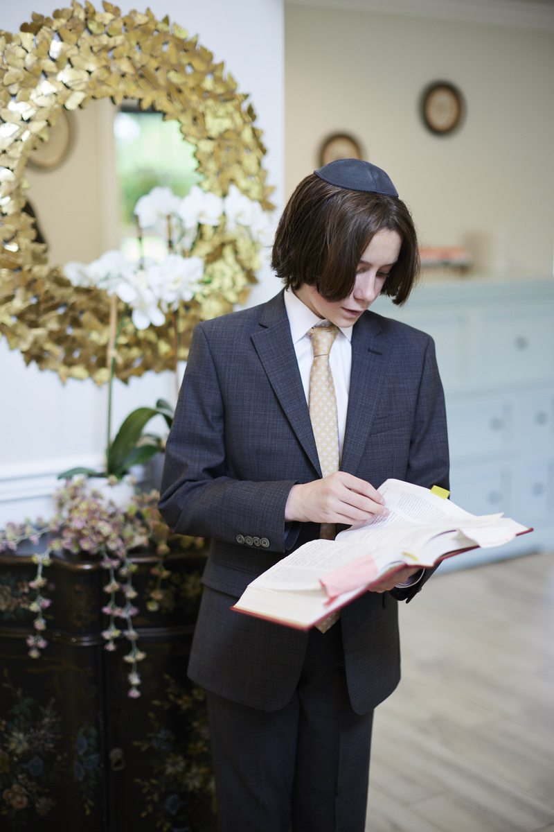 Young man reading Torah at bar mitzvah