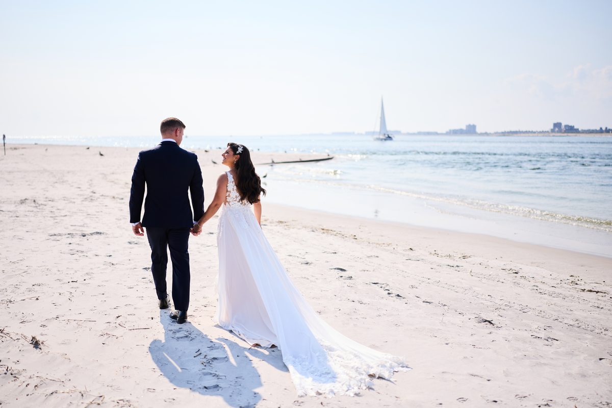 Couple walking on beach at sunset