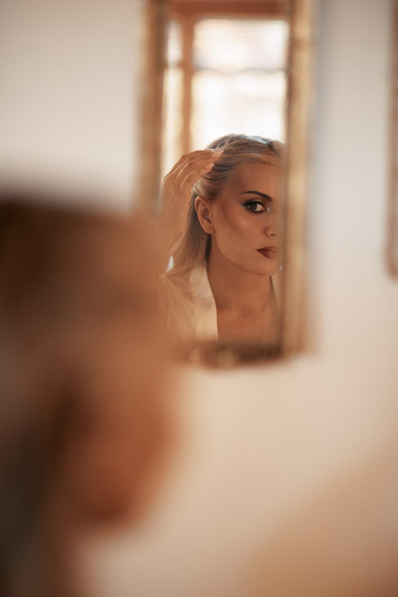 Bride in mirror reflection, editorial portrait