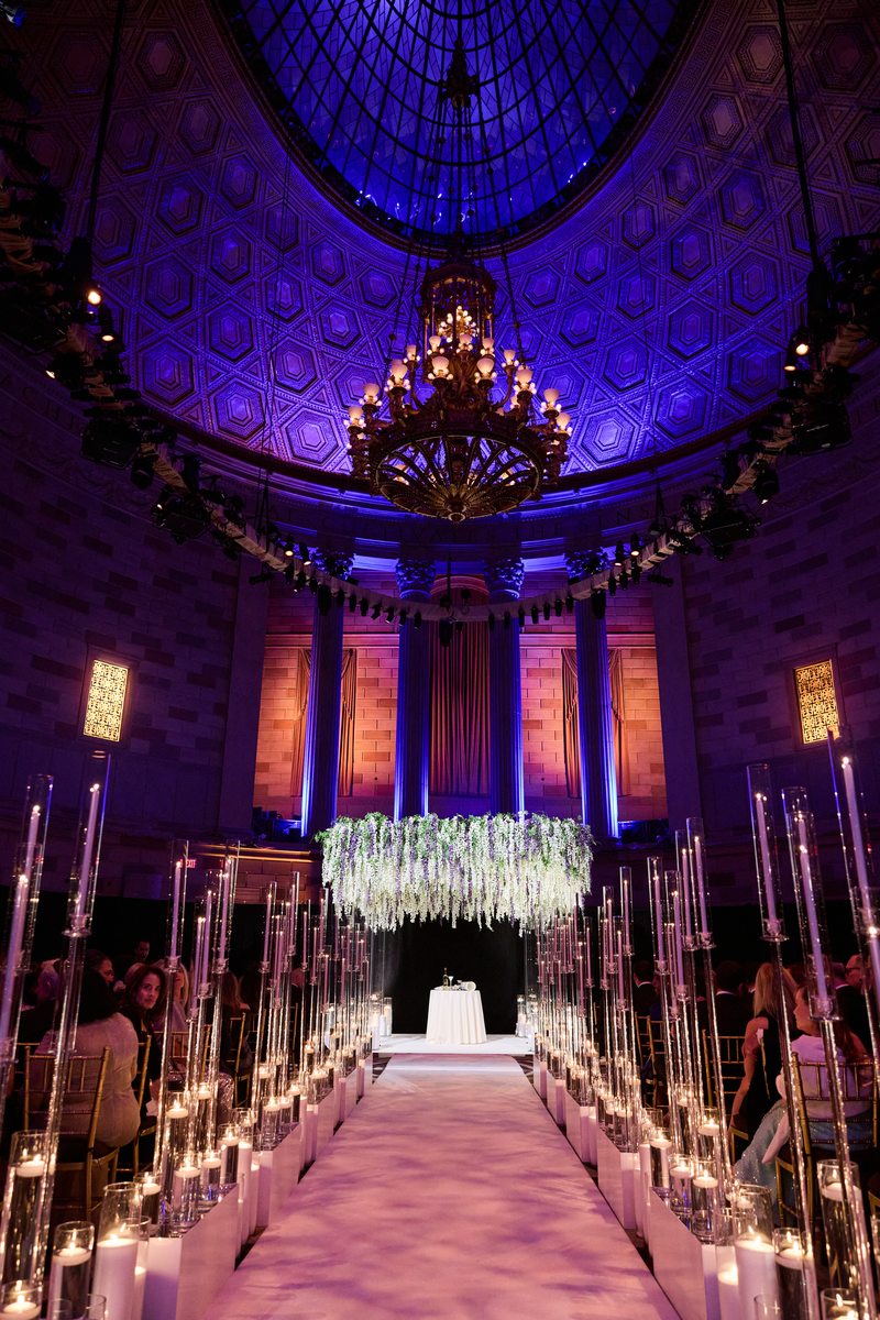 Elegant wedding venue aisle with candles and florals